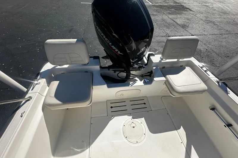 Slide: The Image of 2022 Boston Whaler 170 Montauk boat interior with seating and Mercury outboard motor. - 8