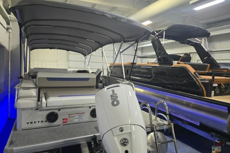 Slide: The Image of 2025 Princecraft Vectra 23 RL pontoon boat with canopy and 150 HP engine in showroom. - 15