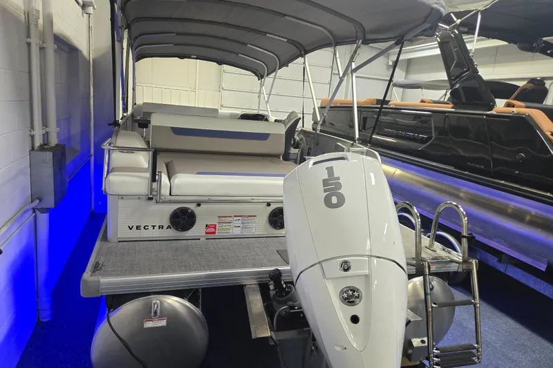 Slide: The Image of 2025 Princecraft Vectra 23 RL pontoon boat with 150 HP engine in showroom. - 3
