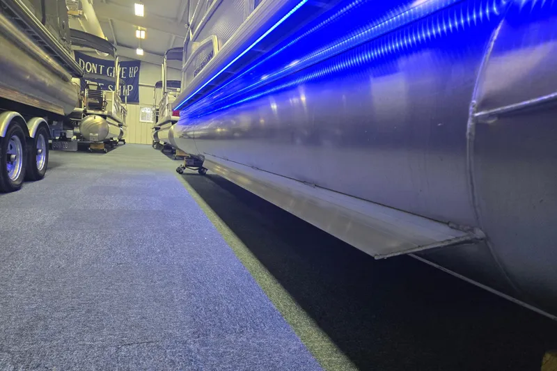 Slide: The Image of 2025 Princecraft Vectra 23 RL pontoon boat with blue LED lights in showroom. - 4