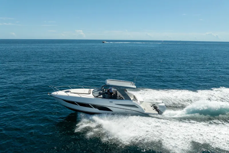 Slide: The Image of 2025 Valiatt 350GT boat cruising on open ocean under clear blue sky. - 2