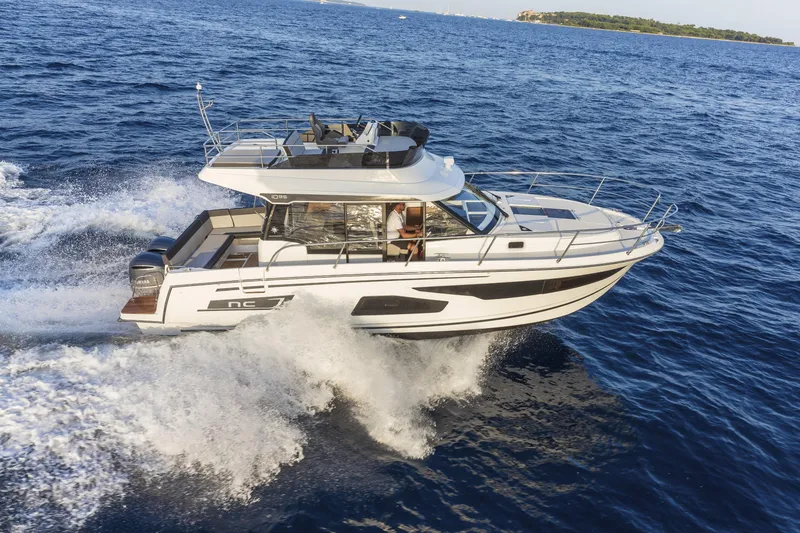 Slide: The Image of 2026 Jeanneau NC1095 Fly cruising on open sea, showcasing sleek design and performance. - 12