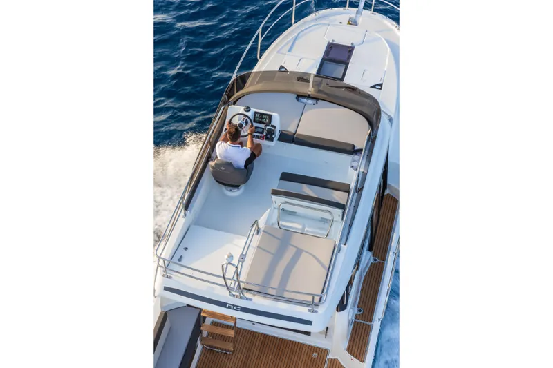 Slide: The Image of 2026 Jeanneau NC1095 Fly yacht cruising on open water, view from above. - 13