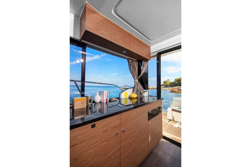 Slide: The Image of Modern kitchen interior of 2026 Jeanneau NC1095 Fly yacht with ocean view. - 9