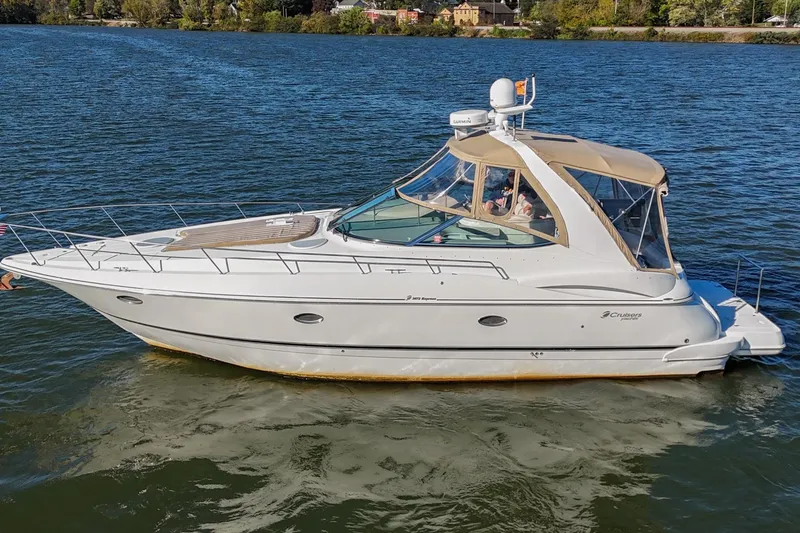 Slide: The Image of 2001 Cruisers Yachts 3672 Express on calm water, showcasing sleek design and luxury features. - 2