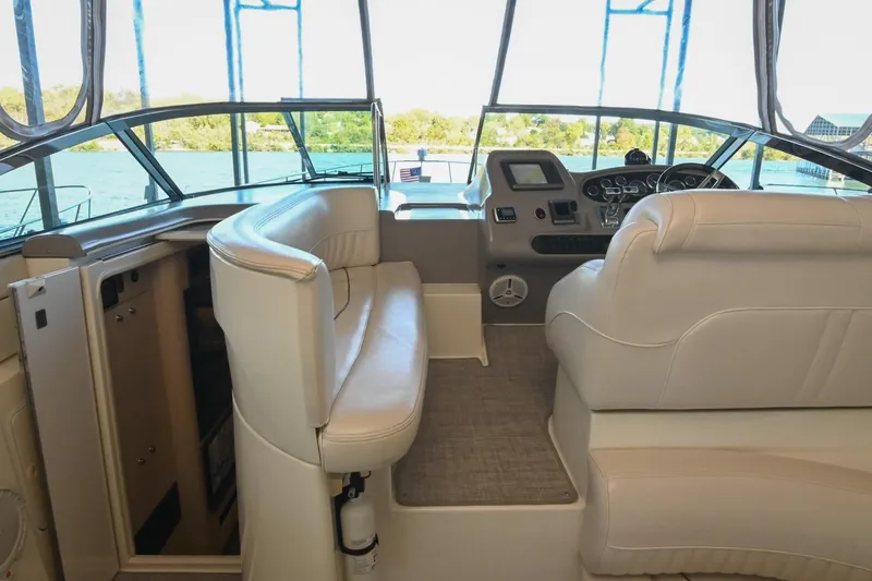 Slide: The Image of Interior of 2001 Cruisers Yachts 3672 Express with white seating and helm view. - 21