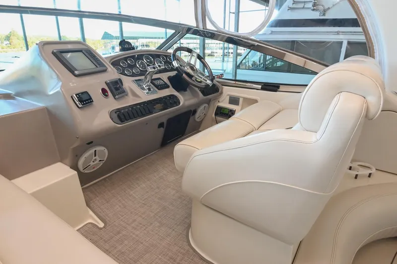 Slide: The Image of 2001 Cruisers Yachts 3672 Express helm with modern controls and plush seating. - 23