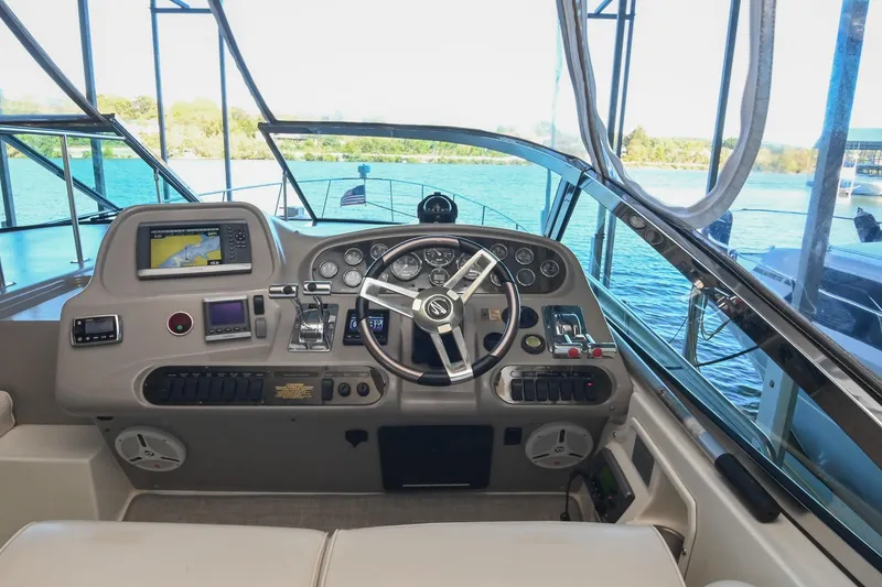 Slide: The Image of 2001 Cruisers Yachts 3672 Express helm with navigation equipment and steering wheel. - 24
