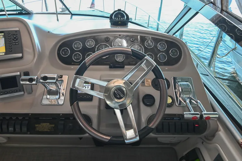 Slide: The Image of Helm of 2001 Cruisers Yachts 3672 Express with steering wheel and control panel. - 25
