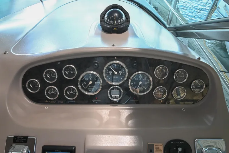 Slide: The Image of Dashboard of 2001 Cruisers Yachts 3672 Express with gauges and compass. - 26