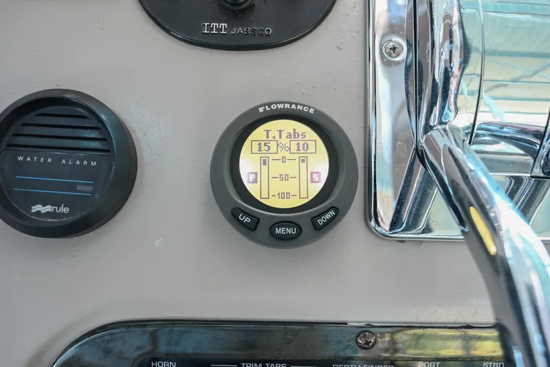 Slide: The Image of 2001 Cruisers Yachts 3672 Express dashboard with trim tab and water alarm controls. - 30