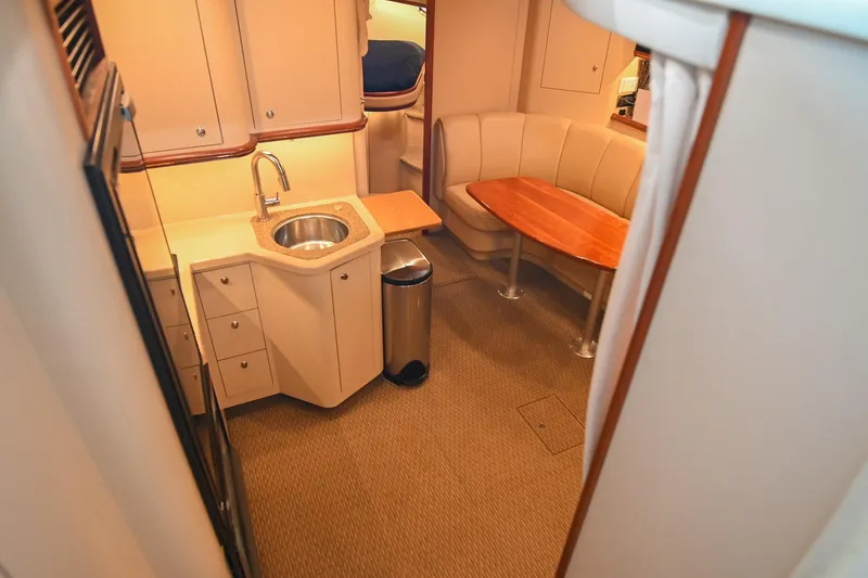 Slide: The Image of Interior of 2001 Cruisers Yachts 3672 Express with kitchenette and seating area. - 42
