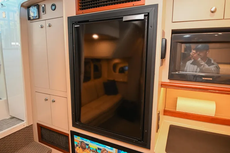 Slide: The Image of Interior of 2001 Cruisers Yachts 3672 Express with fridge and cabinetry. - 44