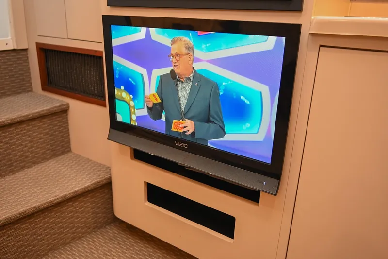 Slide: The Image of Television inside 2001 Cruisers Yachts 3672 Express, displaying a game show. - 45