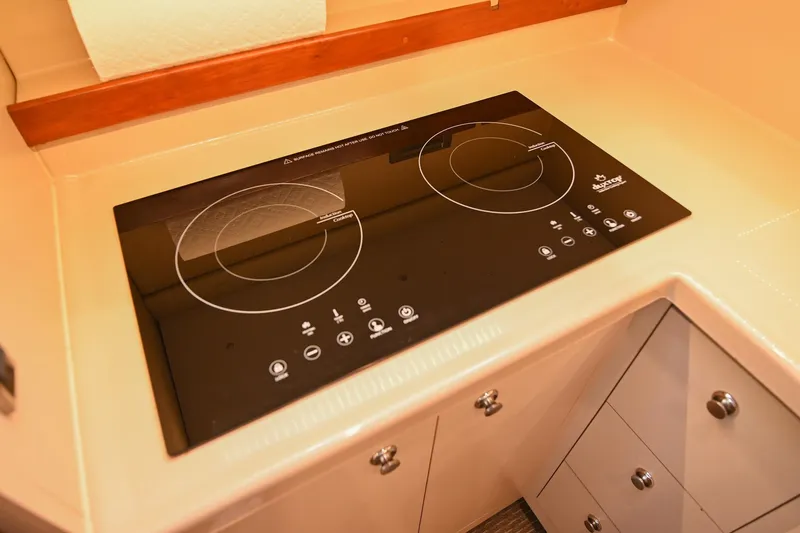 Slide: The Image of Modern induction cooktop in 2001 Cruisers Yachts 3672 Express kitchen area. - 46