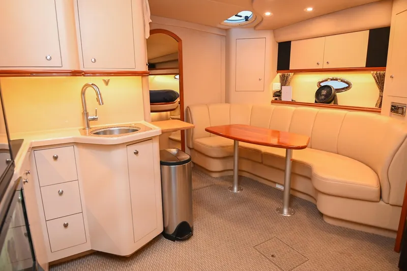 Slide: The Image of Luxurious interior of 2001 Cruisers Yachts 3672 Express with kitchenette and seating area. - 49