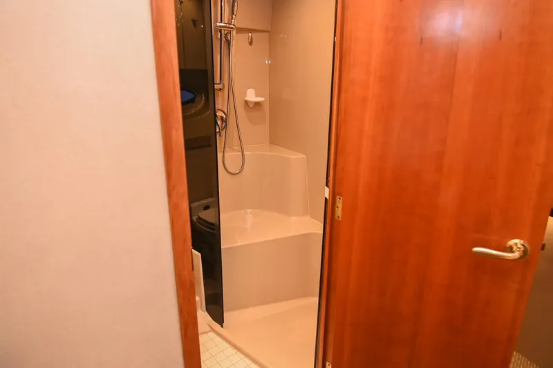 Slide: The Image of 2001 Cruisers Yachts 3672 Express bathroom with shower and wooden door. - 55