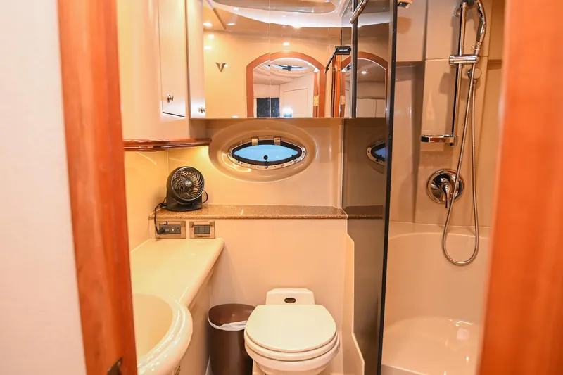 Slide: The Image of 2001 Cruisers Yachts 3672 Express bathroom with shower, toilet, and vanity. - 56