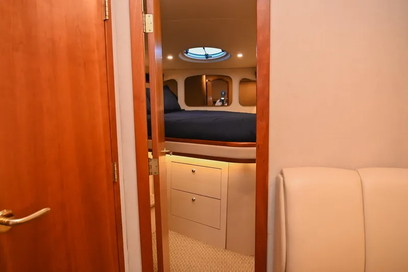 Slide: The Image of Interior cabin of 2001 Cruisers Yachts 3672 Express with cozy bed and wooden accents. - 60