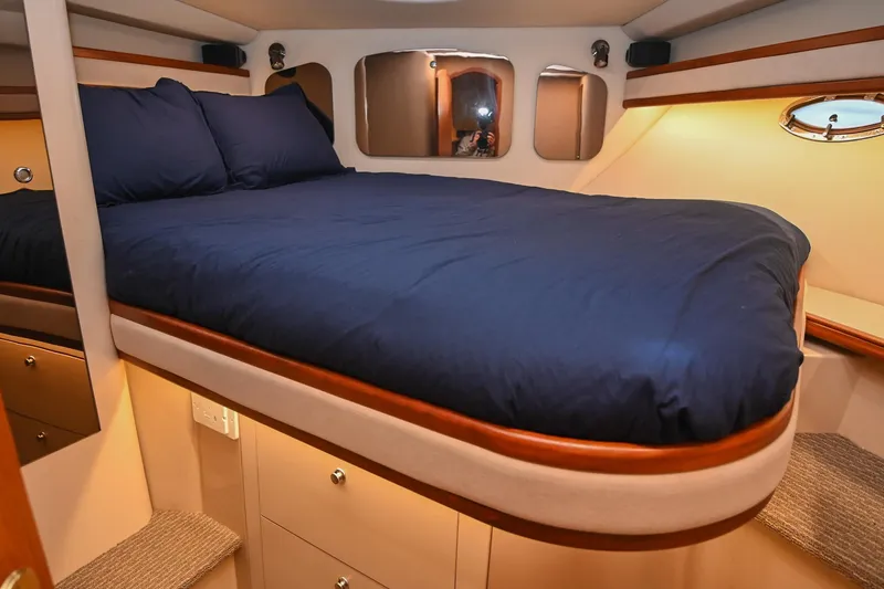 Slide: The Image of Luxurious cabin interior of 2001 Cruisers Yachts 3672 Express with cozy bedding. - 61