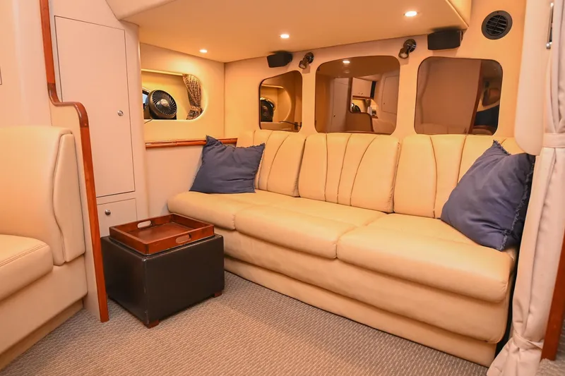 Slide: The Image of Luxurious interior of 2001 Cruisers Yachts 3672 Express with beige sofa and blue cushions. - 63