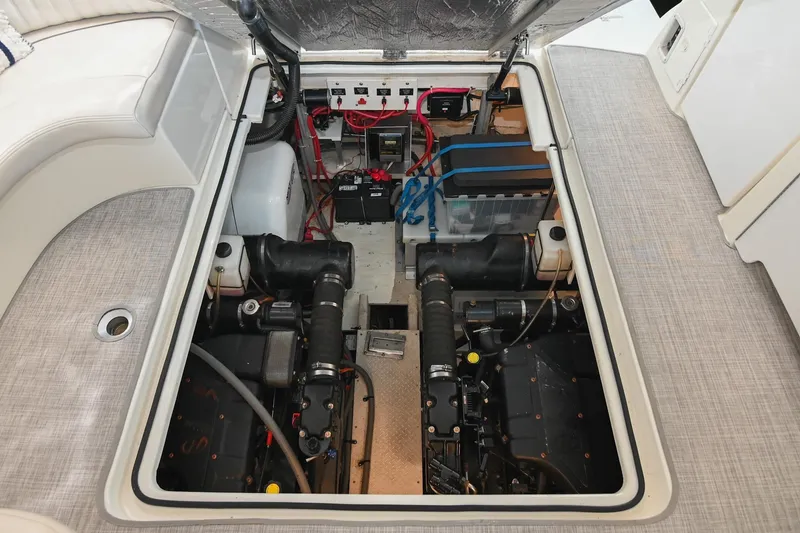 Slide: The Image of Engine compartment of a 2001 Cruisers Yachts 3672 Express, showcasing mechanical components and wiring. - 66