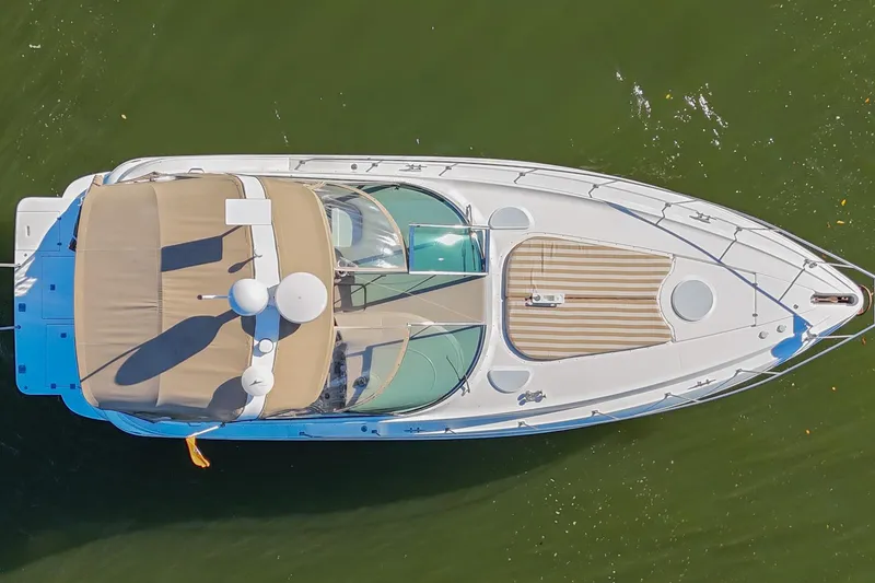 Slide: The Image of Aerial view of 2001 Cruisers Yachts 3672 Express on green water. - 8