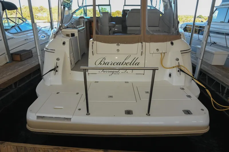 Slide: The Image of 2001 Cruisers Yachts 3672 Express docked, rear view with "Barcabella" name visible. - 9