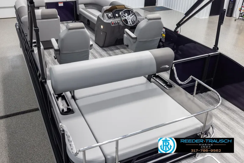 Slide: The Image of 2025 Bennington 21 SSB pontoon boat interior with gray seating and modern dashboard. - 11