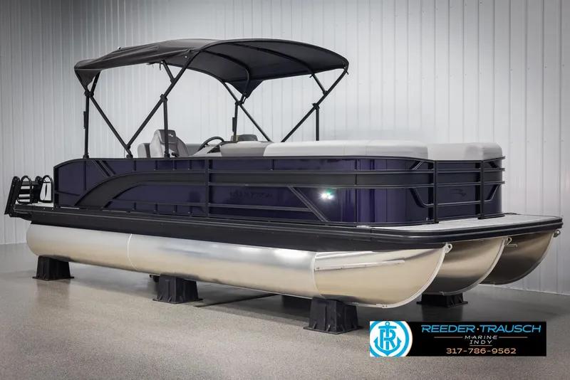 Slide: The Image of 2025 Bennington 21 SSB pontoon boat with canopy, displayed indoors. - 3