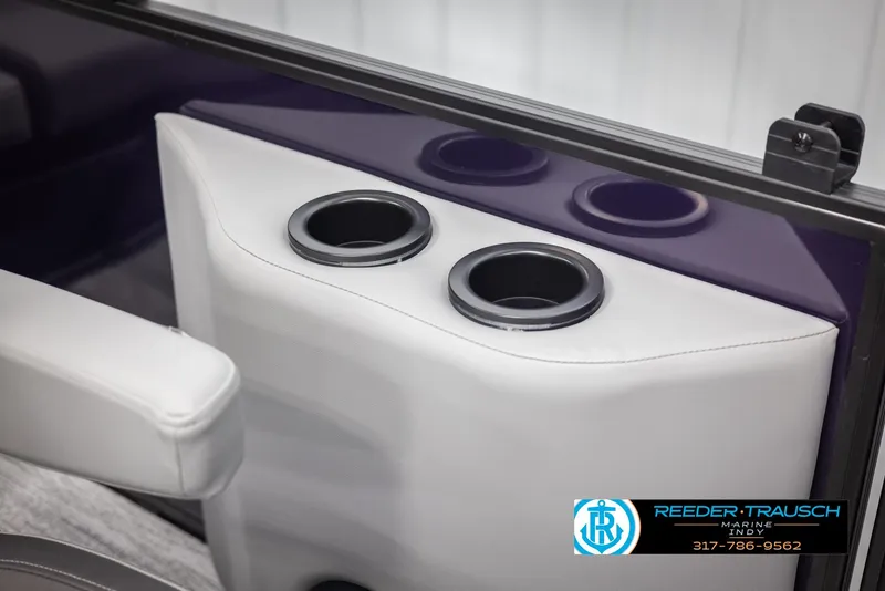 Slide: The Image of 2025 Bennington 21 SSB boat interior with cup holders and white upholstery. - 40