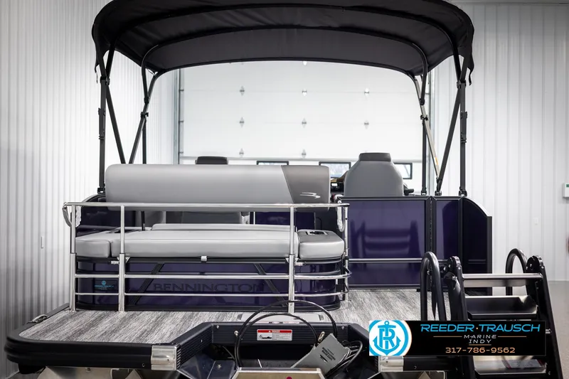 Slide: The Image of 2025 Bennington 21 SSB pontoon boat in showroom, featuring sleek design and comfortable seating. - 7