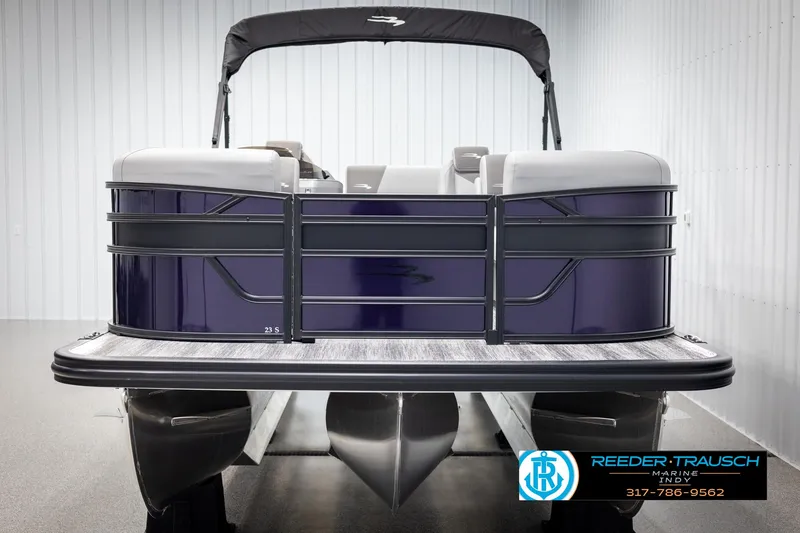 Slide: The Image of 2025 Bennington 21 SSB pontoon boat in showroom, front view, with Reeder-Trausch Marine logo. - 8