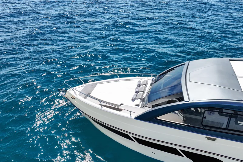 Slide: The Image of 2025 VALIATT YACHTS 380 Bowrider cruising on sparkling blue ocean waters. - 16