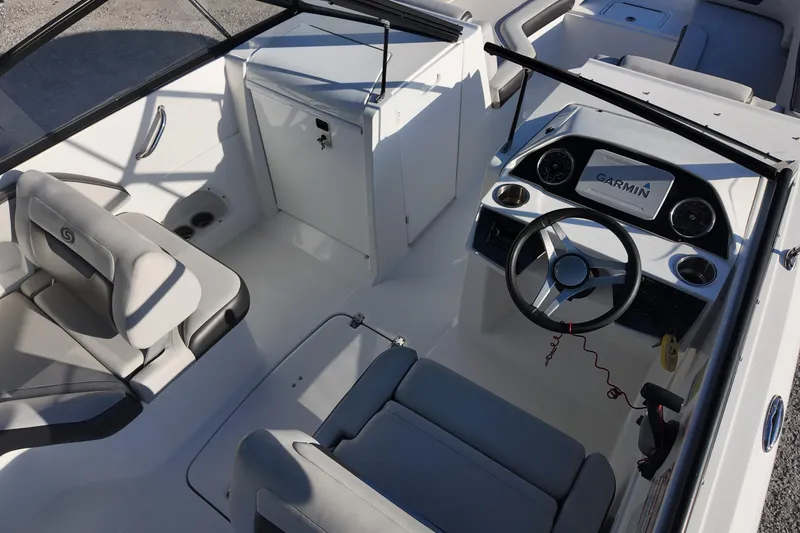 Slide: The Image of 2022 Hurricane SunDeck 235 OB boat interior with Garmin navigation system and comfortable seating. - 14