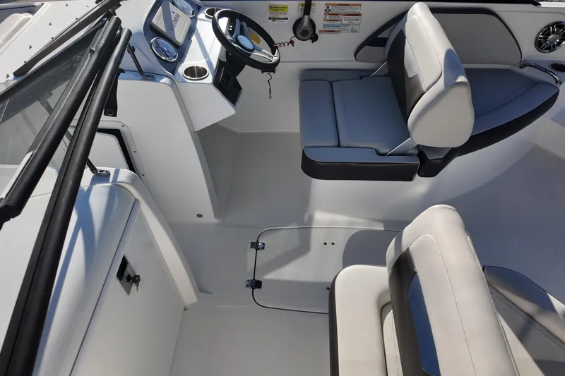 Slide: The Image of 2022 Hurricane SunDeck 235 OB boat interior with steering wheel and seating. - 18