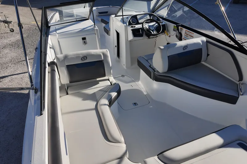 Slide: The Image of 2022 Hurricane SunDeck 235 OB interior with sleek seating and modern dashboard design. - 20