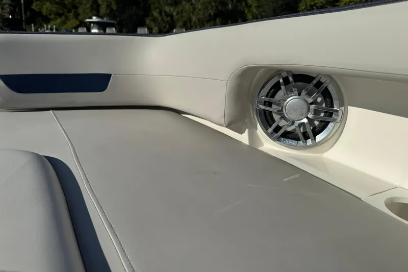 Slide: The Image of 2022 Hurricane SunDeck 235 OB boat interior with speaker and cushioned seating. - 26