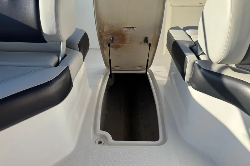 Slide: The Image of 2022 Hurricane SunDeck 235 OB boat storage compartment with open hatch and seating. - 27