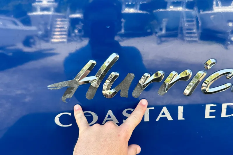 Slide: The Image of Close-up of 2022 Hurricane SunDeck 235 OB logo on blue surface. - 30