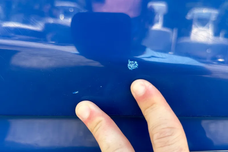 Slide: The Image of Close-up of a 2022 Hurricane SunDeck 235 OB with a small paint chip. - 31