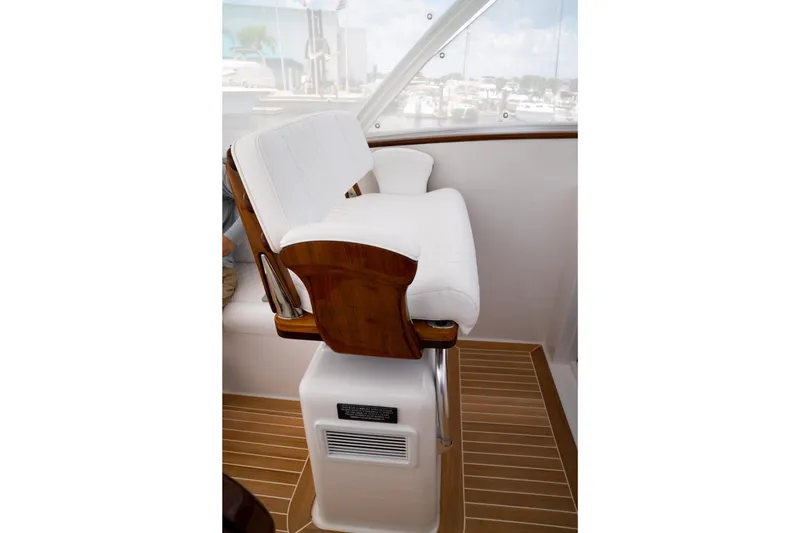 Slide: The Image of Luxury seating on 2026 Front Runner 47WA boat, featuring white cushions and wooden accents. - 14