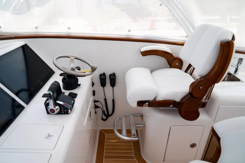 Slide: The Image of Helm of 2026 Front Runner 47WA boat with modern controls and luxurious seating. - 15