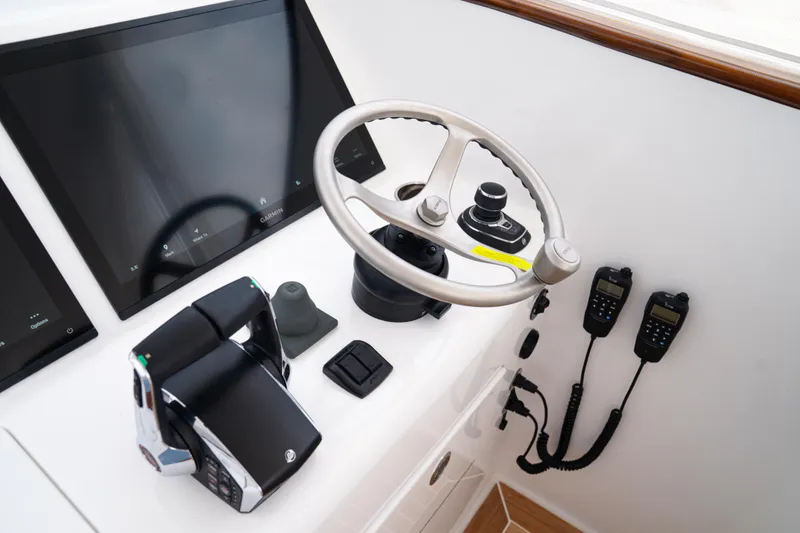 Slide: The Image of Control panel of 2026 Front Runner 47WA boat with steering wheel and navigation screens. - 17