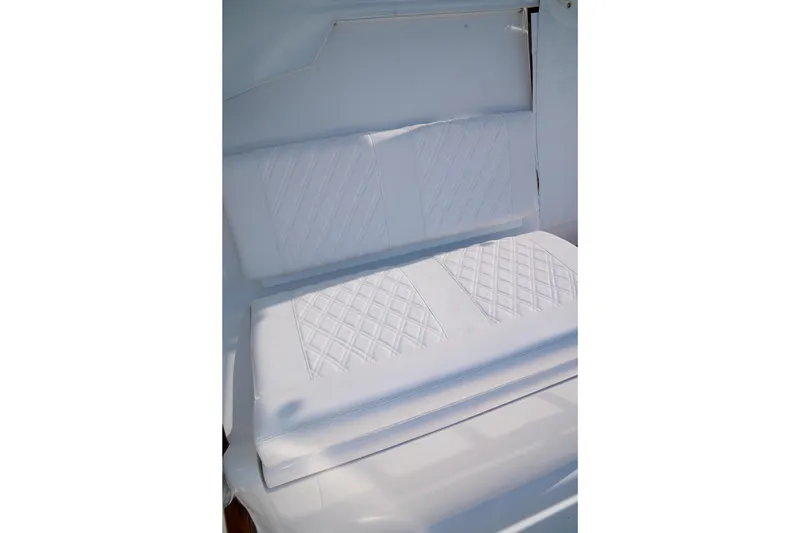 Slide: The Image of White cushioned seating on 2026 Front Runner 47WA boat, featuring diamond stitching. - 19