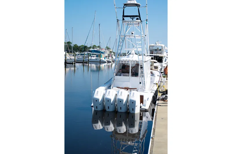 Slide: The Image of Front Runner 47WA 2026 boat docked with multiple outboard engines. - 22
