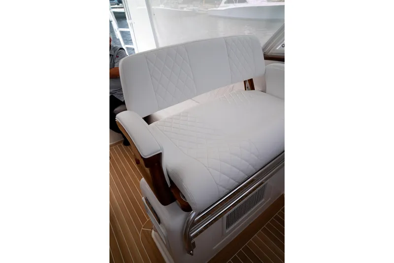 Slide: The Image of Luxurious white seating on 2026 Front Runner 47WA boat, featuring quilted design and wooden accents. - 23