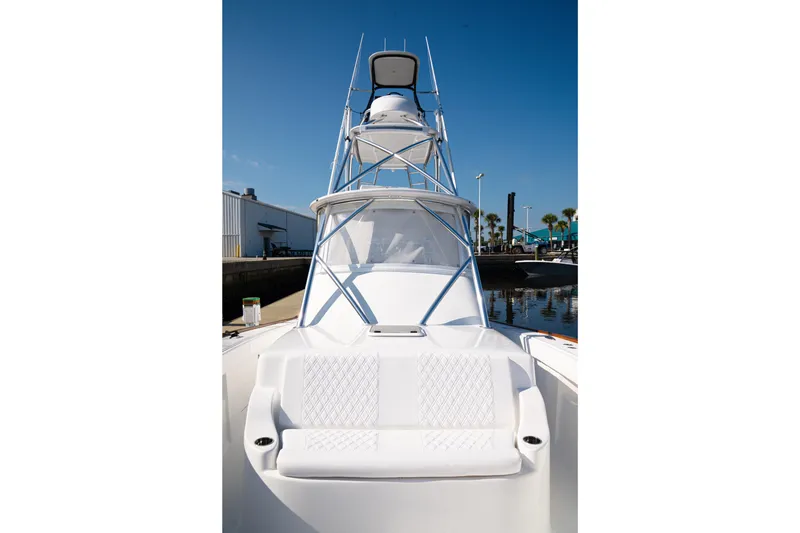 Slide: The Image of 2026 Front Runner 47WA boat with sleek design and tower, docked under clear blue sky. - 25