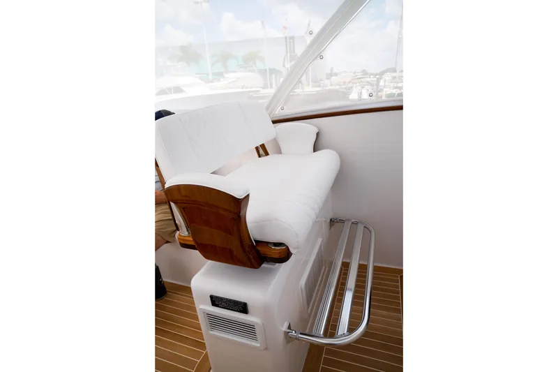 Slide: The Image of Luxury seating on 2026 Front Runner 47WA boat, featuring white upholstery and wooden accents. - 26