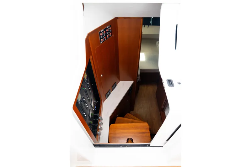 Slide: The Image of Interior view of 2026 Front Runner 47WA boat, featuring wooden stairs and control panel. - 31
